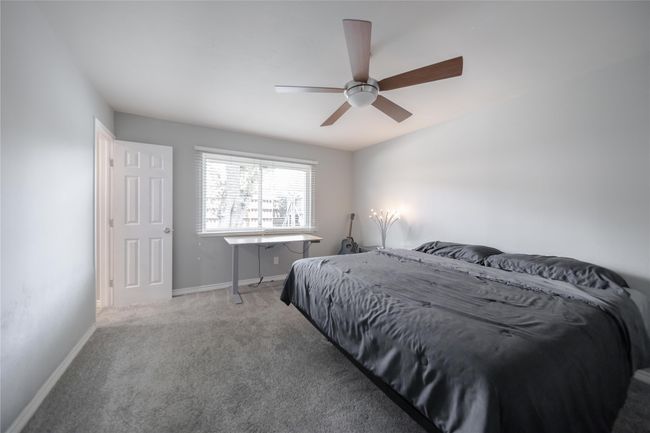 Carpeted bedroom with baseboards and a ceiling fan | Image 22