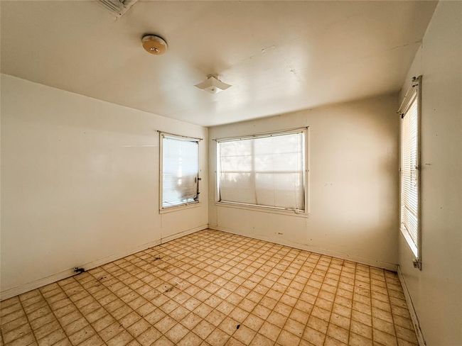 1st bedroom -Bright and inviting bedroom with ample natural light and potential for customization. | Image 11
