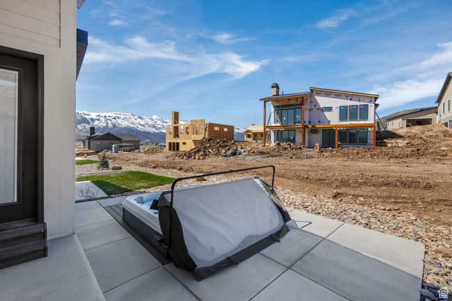 Nestled off the main level, a recessed hot tub offers an ideal escape for relaxation and rejuvenation, seamlessly integrating with the peaceful surroundings and providing the perfect spot to soak in breathtaking mountain views. | Image 47
