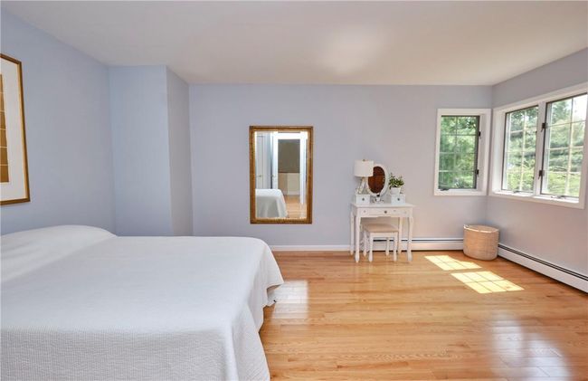 Bedroom with light hardwood / wood-style flooring and baseboard heating | Image 31