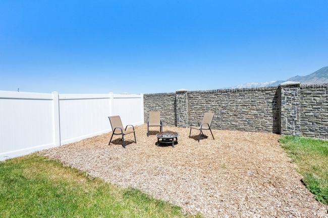 View of yard featuring an outdoor fire pit and a mountain view | Image 32