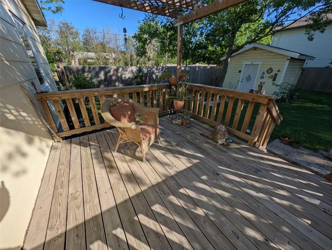 Deck featuring a pergola, a fenced backyard & storage / shop. | Image 26