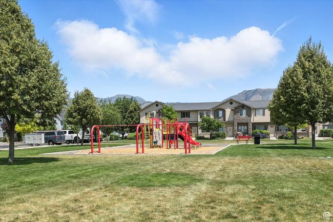 Community playground with a yard and a mountain view | Image 32