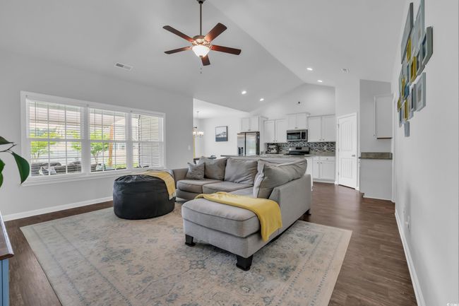 Living room featuring recessed lighting, dark wood-style floors, visible vents, a ceiling fan, and baseboards | Image 16