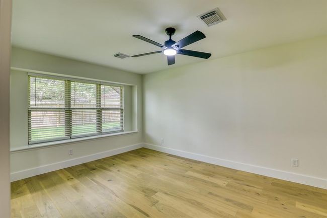 Primary bedroom with seating by window | Image 21