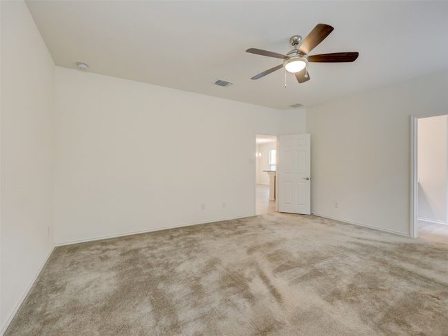 Carpet and ceiling fan in primary bedroom | Image 24