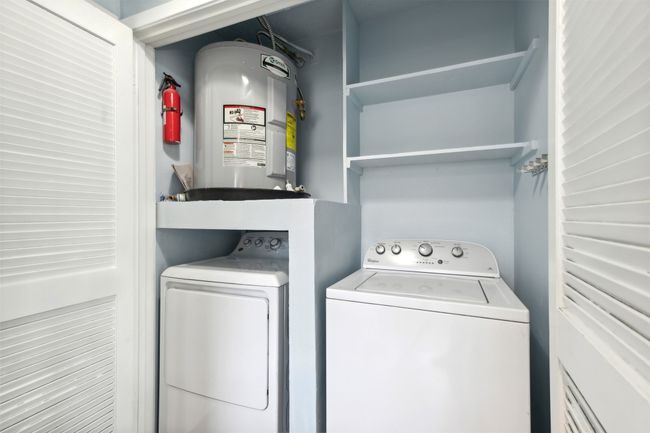 Washroom with laundry area, water heater, and washing machine and clothes dryer | Image 11