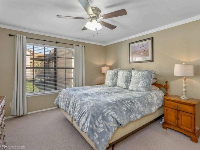 Bedroom featuring light carpet, ornamental molding, baseboards, and multiple windows | Image 15