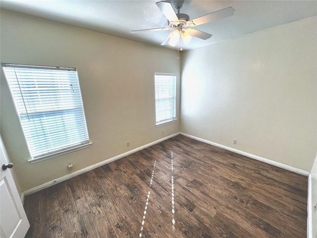 Unfurnished room with a ceiling fan and wood finished floors | Image 7