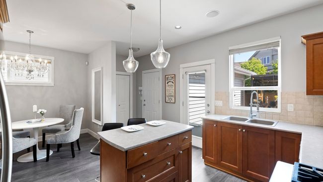 Kitchen featuring a sink, dark wood-style floors, and light countertops | Image 13