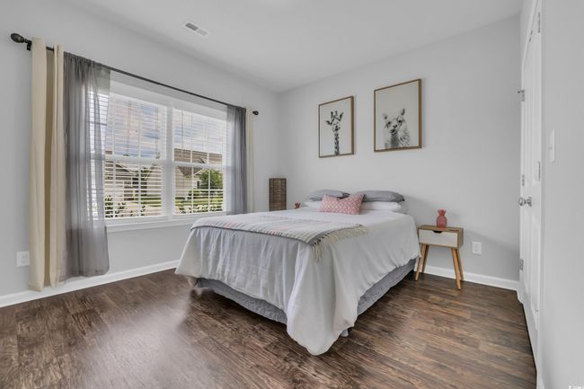 Bedroom featuring visible vents, wood finished floors, and baseboards | Image 10