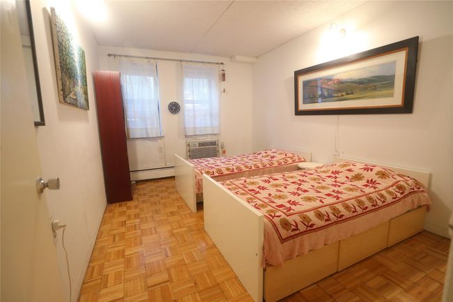 Bedroom with baseboard heating and a wall mounted air conditioner | Image 21