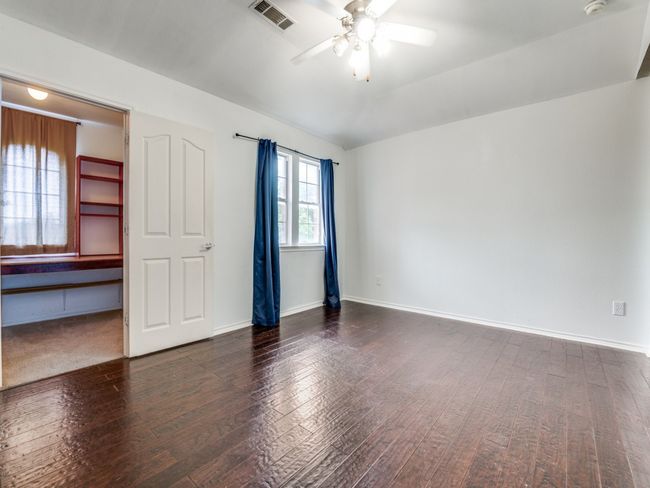 Unfurnished room featuring baseboards, visible vents, wood finished floors, and ceiling fan | Image 13