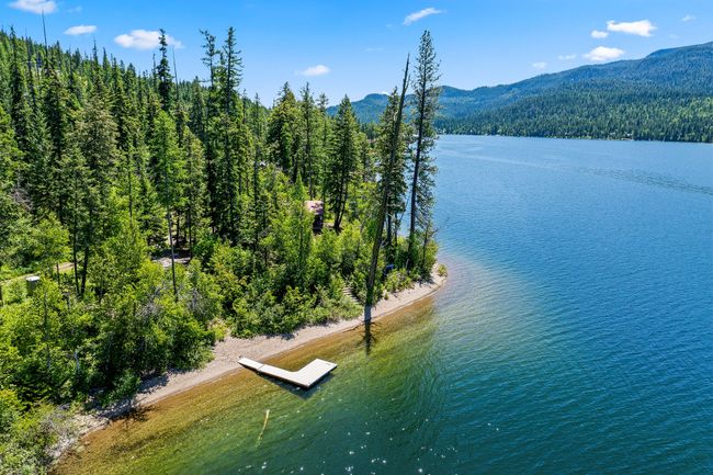 Aerial view of Swan Lake shoreline with a mountainous background and a boat dock | Image 43