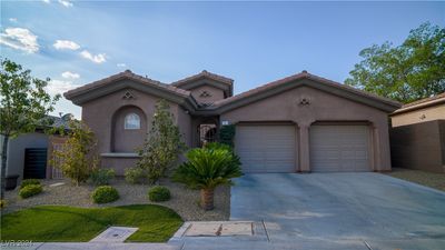 Front of the home surrounded by a lush landscaping | Image 1