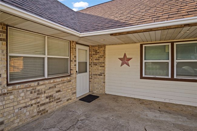 Entrance to property featuring a shingled roof | Image 9