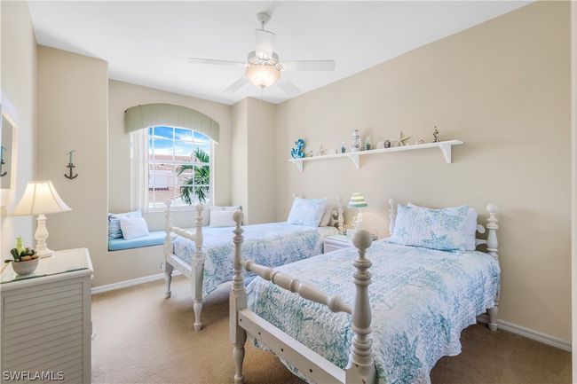 3rd bedroom offers twin beds, seating area to curl up with a good book. Lots of natural light. | Image 25