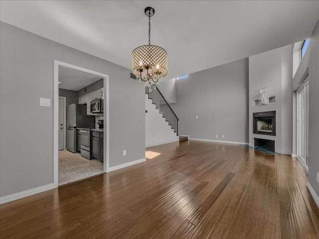 Living room featuring hardwood / wood-style floors and a notable chandelier | Image 9