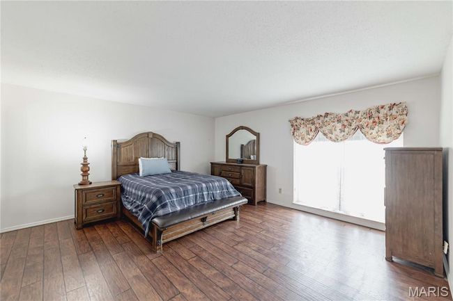 Bedroom with dark wood finished floors and baseboards | Image 30