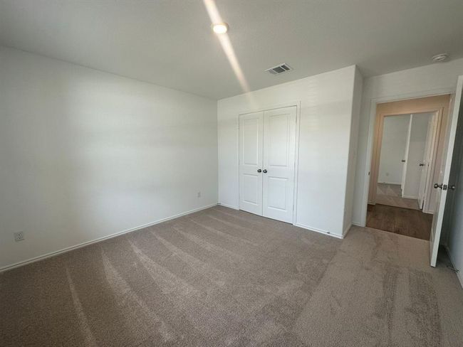 Unfurnished bedroom with carpet, baseboards, and a closet | Image 5