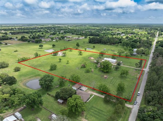 A country home on a substantial amount of land, secluded near the end of a dead-end street, offers a serene escape from the hustle and bustle of daily life. With 7.42 +/- acres, there's plenty of space to explore, whether it's for gardening, outdoor activities, or simply enjoying the beauty of nature | Image 43
