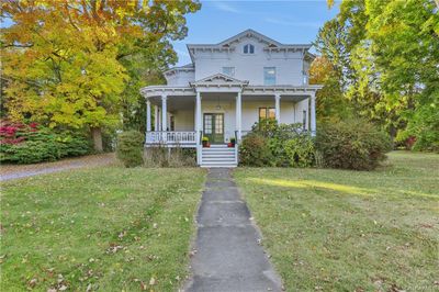 View of front facade featuring a front yard and a porch | Image 1