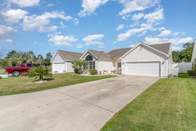 Ranch-style home with a garage and a front lawn | Image 2