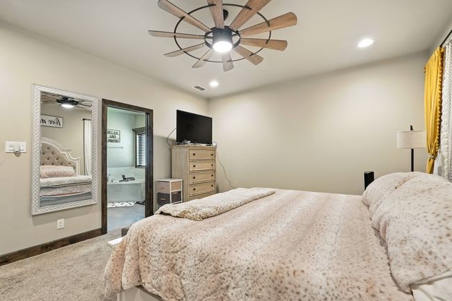 Bedroom featuring carpet floors, recessed lighting, ensuite bath, and ceiling fan | Image 15