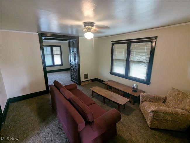 Second-Floor dining room featuring ornamental molding, ceiling fan, and dark carpet | Image 19