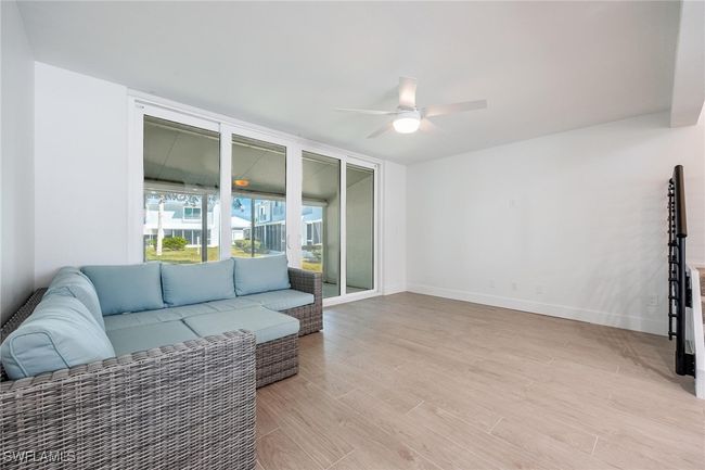 Living room with light hardwood / wood-style flooring and ceiling fan | Image 16