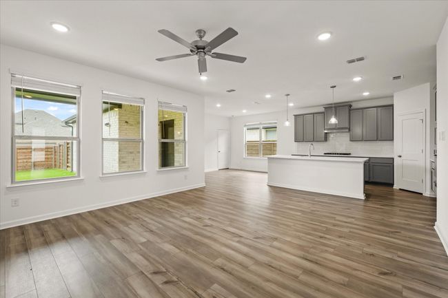 Living room with recessed lighting, wood finished floors, and a ceiling fan | Image 13