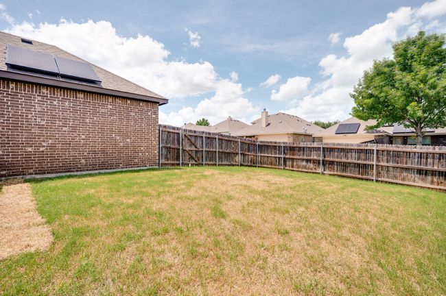 View of fenced backyard | Image 25