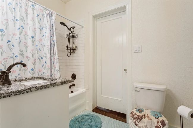 Bathroom with toilet, shower / tub combo, and vanity | Image 23