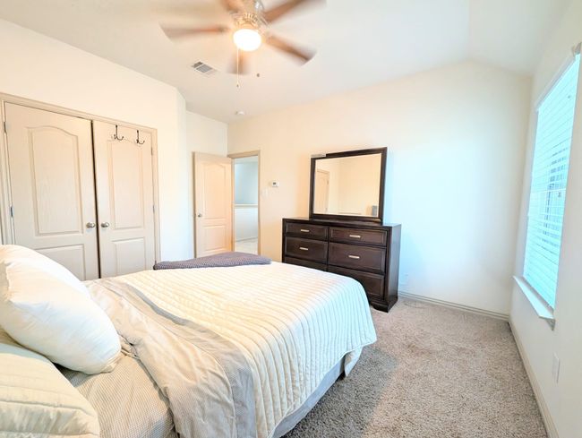 Bedroom with light carpet, a closet, and ceiling fan | Image 14