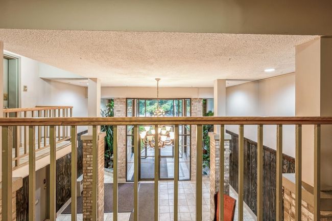 Hall featuring a textured ceiling and a chandelier | Image 4