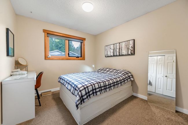 Bedroom featuring a closet, baseboards, a textured ceiling, and carpet flooring | Image 20