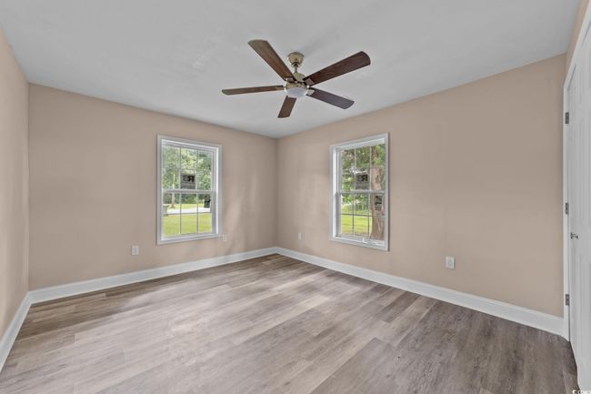 Unfurnished room featuring wood finished floors and a ceiling fan | Image 32