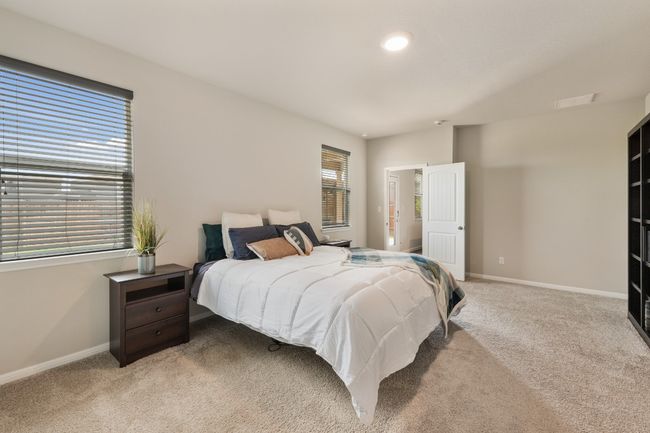 Primary Bedroom is located at the back of the home and has plenty of space for large furniture, seating area and storage. | Image 13