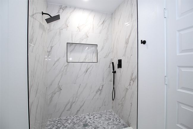 Full bathroom featuring a marble finish shower | Image 15