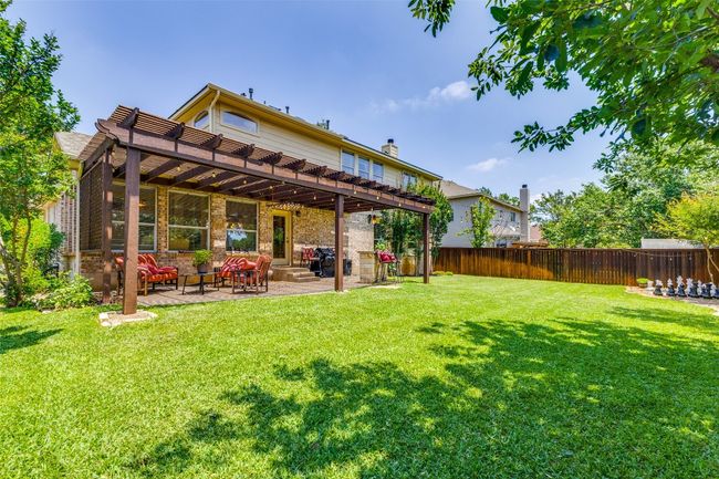 Back of property with a pergola, a patio, and a chimney | Image 23