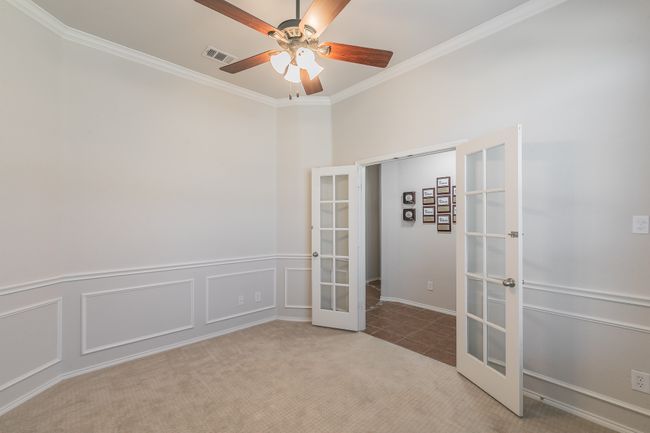 Flex space-Office featuring crown molding, ceiling fan, french doors, and a decorative wall | Image 17