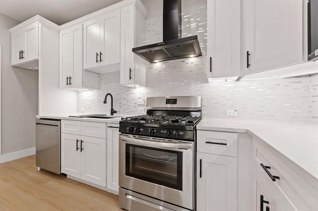 Gourmet kitchen awaits. A spacious kitchen with top-of-the-line stainless steel appliances and a beautiful quartz island for meal prep and entertainment. | Image 7