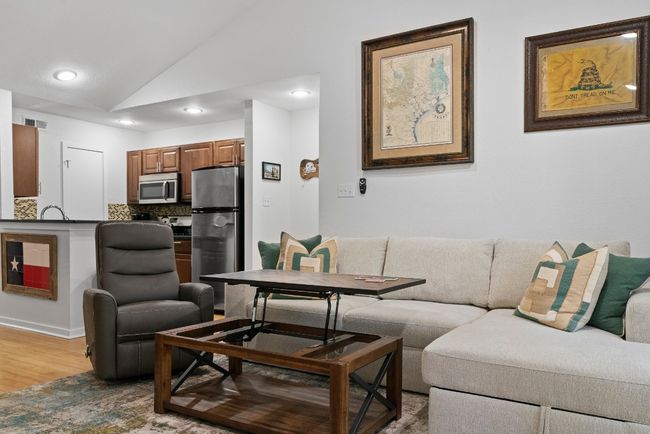 Living area with vaulted ceiling, wood finished floors, and recessed lighting | Image 10