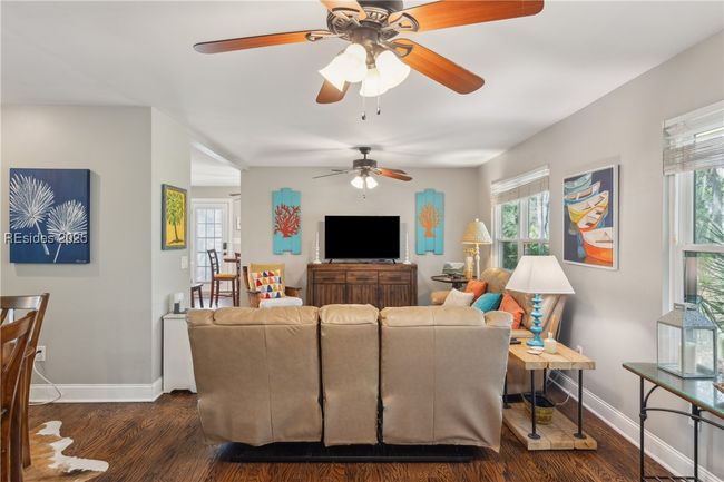 Primary living room with hardwood floors, ample seating, bright natural lighting, smooth ceilings. | Image 33