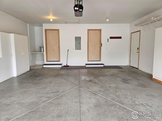 Attached 2 car garage with access to crawl space, appliance closet and side yard. Includes storage cabinets | Image 32