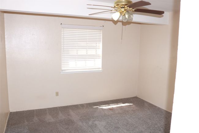 Carpeted spare room with a ceiling fan | Image 7