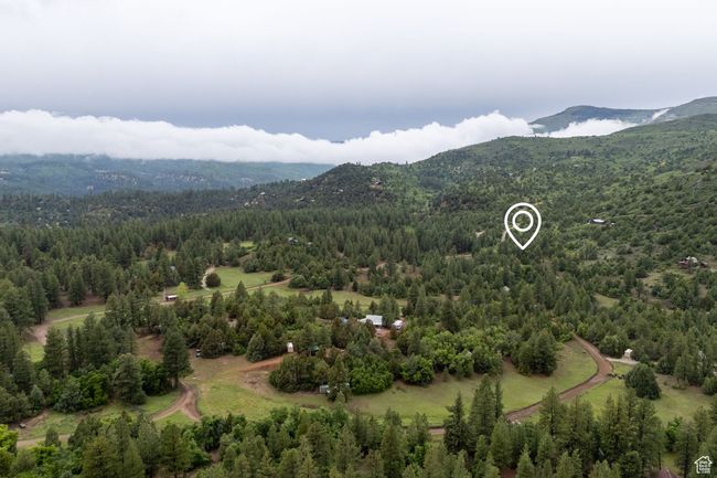 Bird's eye view of a mountainous background and a heavily wooded area | Image 11