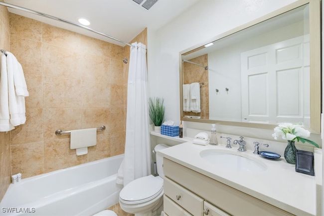 Full guest bathroom featuring vanity, toilet, and shower / tub combo | Image 16