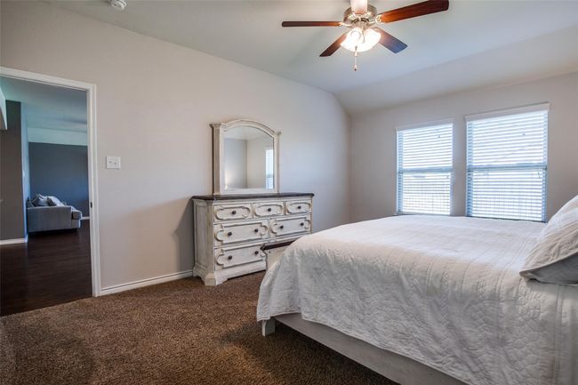 Carpeted bedroom featuring lofted ceiling and ceiling fan | Image 14
