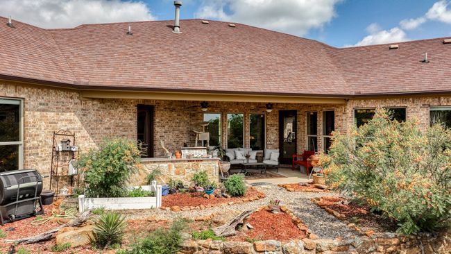Rear view of property featuring an outdoor hangout area, a patio, ceiling fan, and brick siding | Image 36